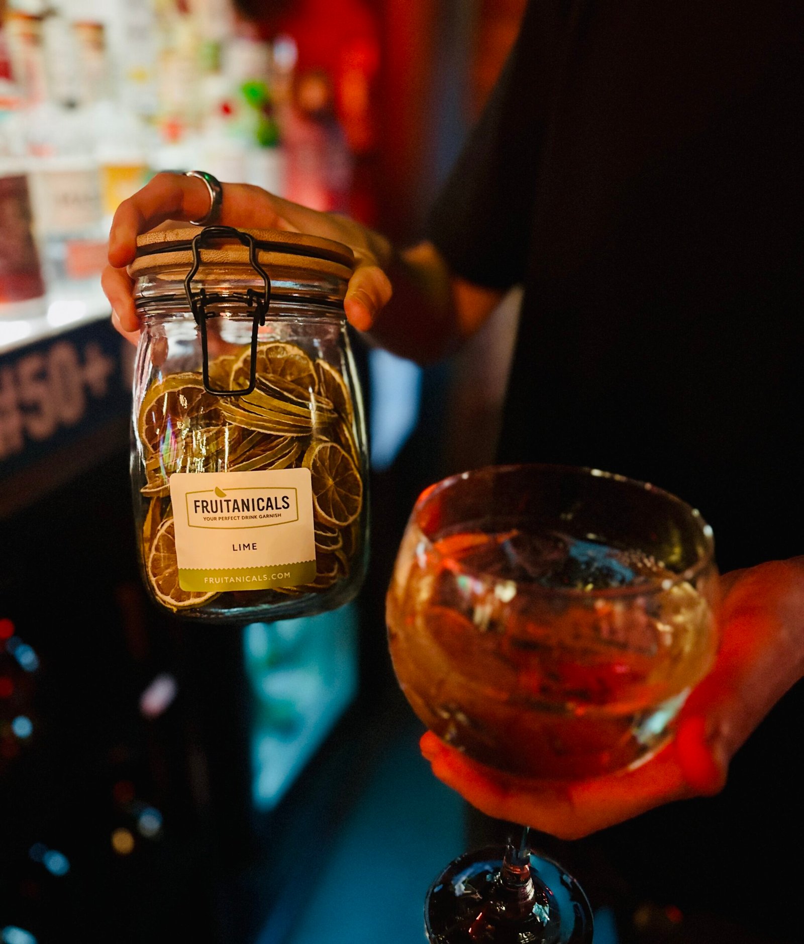 dehydrated fruit jar in a bar with bartender holding