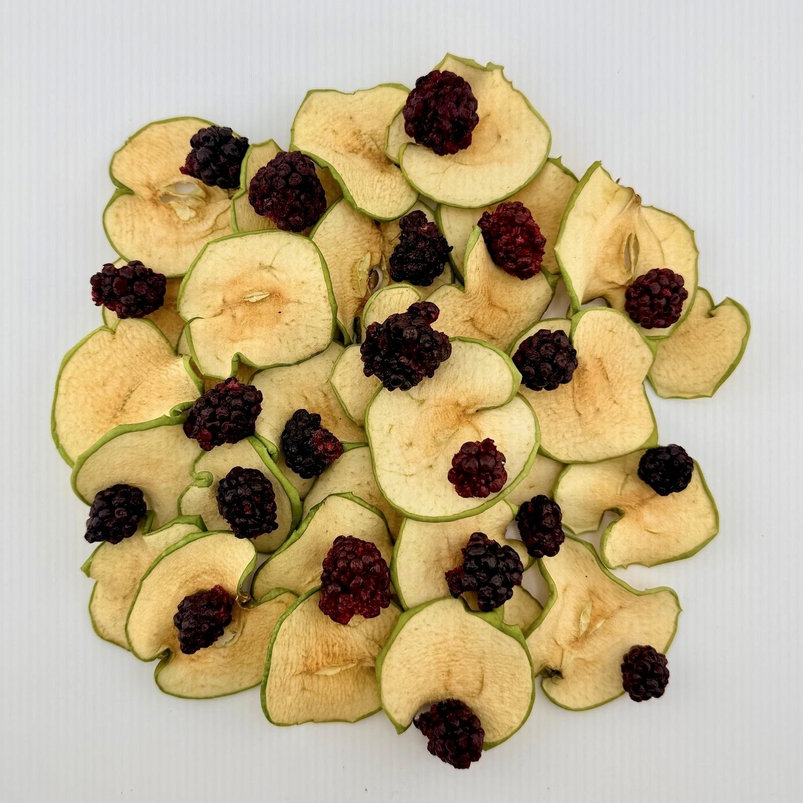 Dehydrated apple and blackberry garnish pieces laid out on white